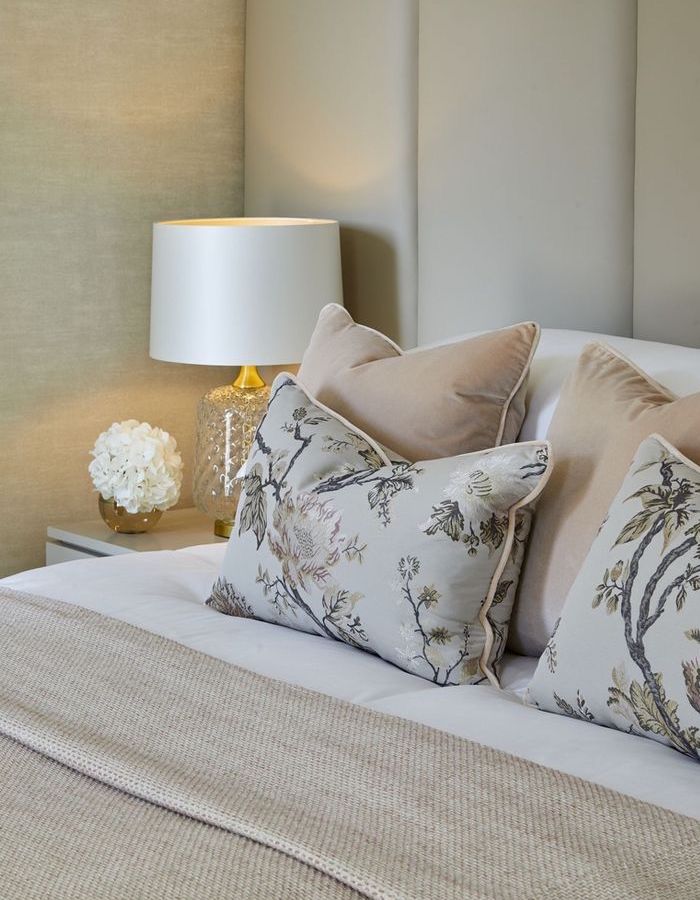 Bed scatter cushions with a floral pattern.