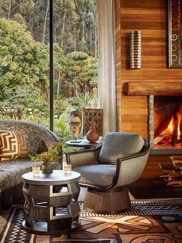 East African inspired seating in a lodge with wooden fireplace.